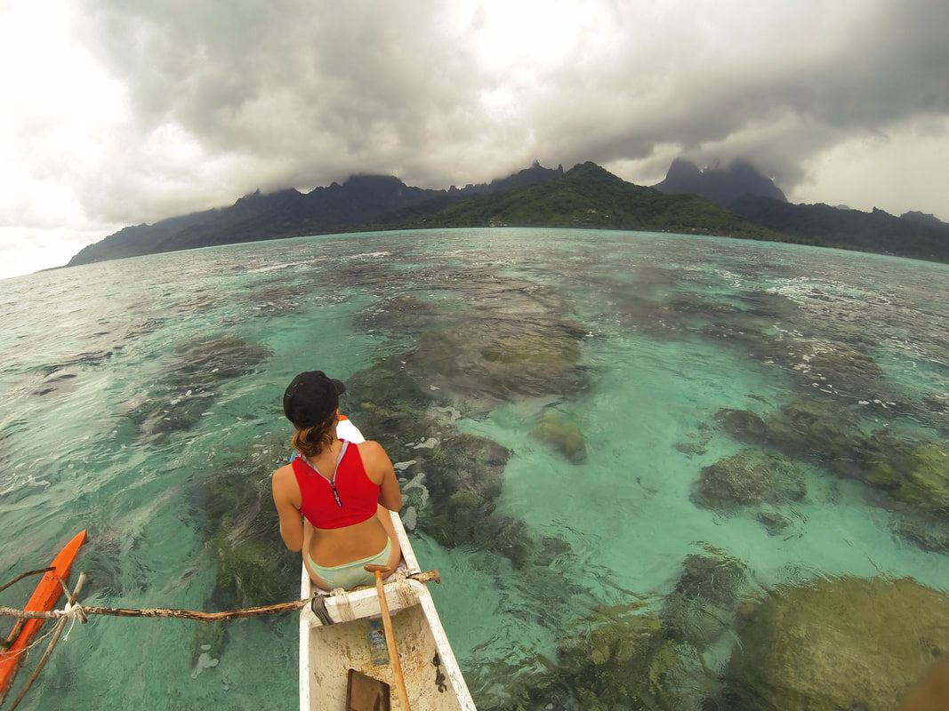 self inquiry serene boat tahiti ocean island beach self help outrigger canoe coral fish clouds sky girl exercise
